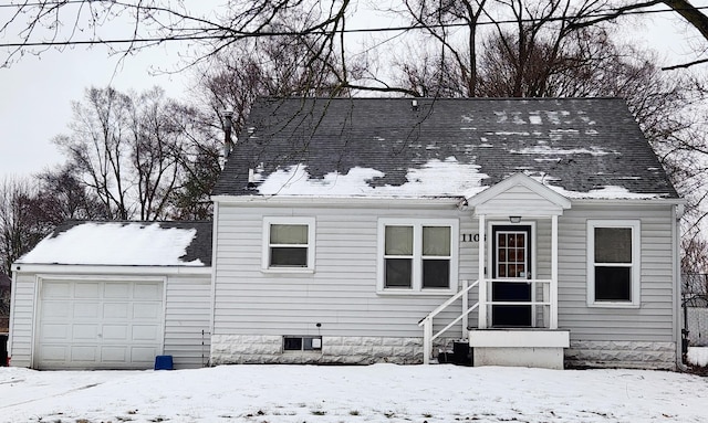 cape cod home with a garage