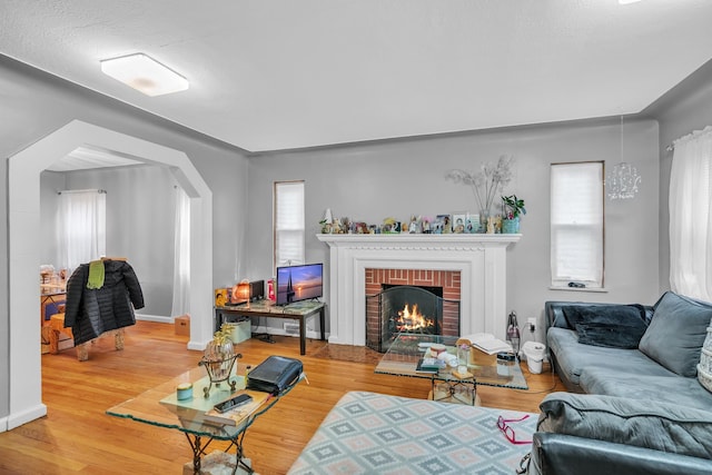 living room with hardwood / wood-style floors and a fireplace