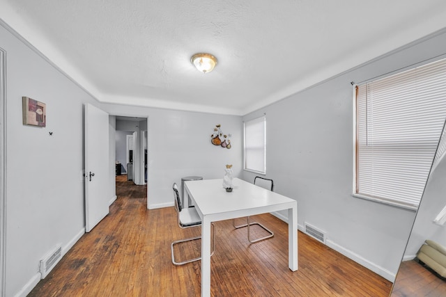 office with dark wood-type flooring and a textured ceiling