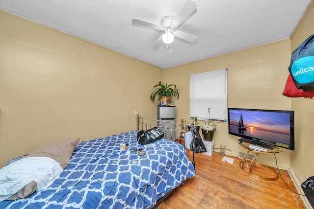 bedroom with hardwood / wood-style flooring and ceiling fan