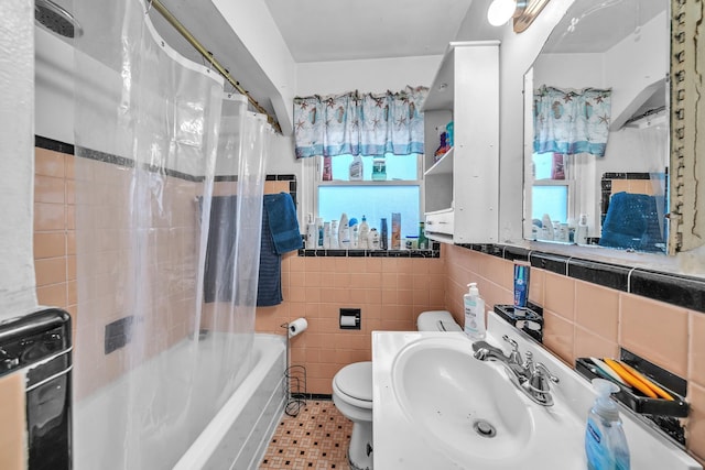 full bathroom with tile patterned floors, toilet, sink, tile walls, and shower / bath combo with shower curtain