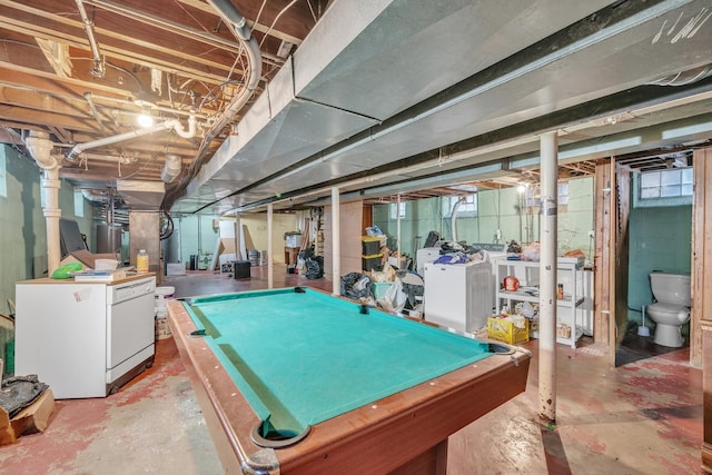 playroom featuring concrete floors and washer and clothes dryer