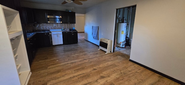 kitchen featuring water heater, dark wood-type flooring, heating unit, and ceiling fan