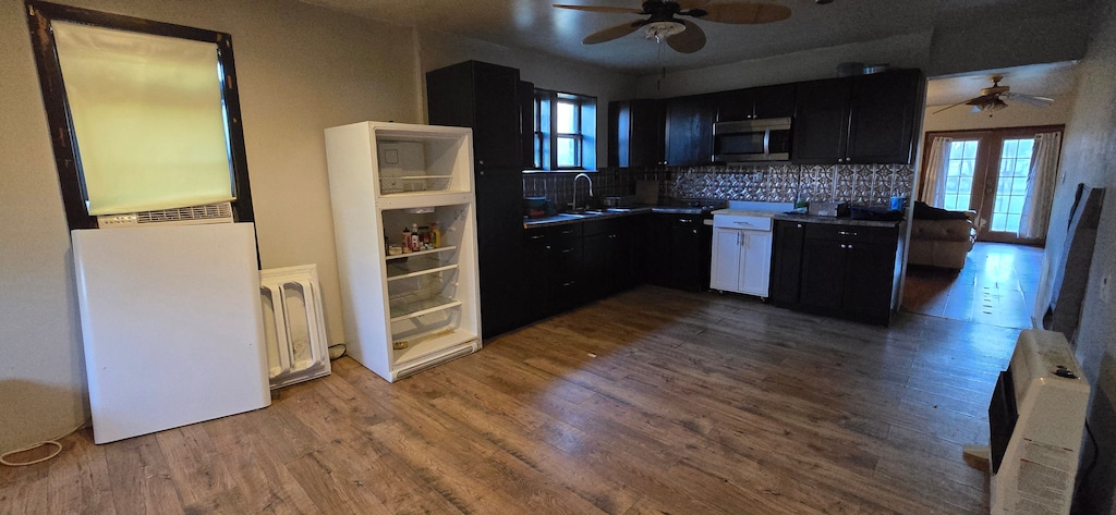 kitchen with hardwood / wood-style flooring, plenty of natural light, sink, and backsplash