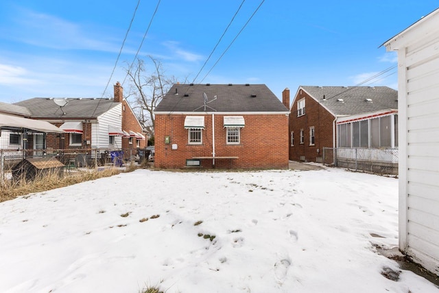 view of snow covered rear of property