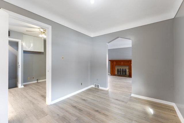 empty room featuring ceiling fan and light hardwood / wood-style flooring