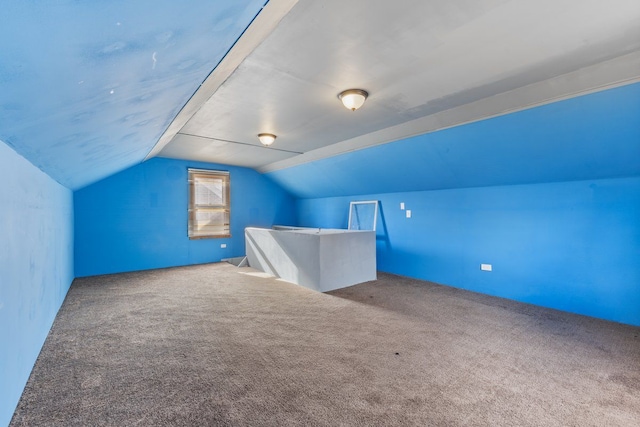 bonus room featuring vaulted ceiling and carpet flooring