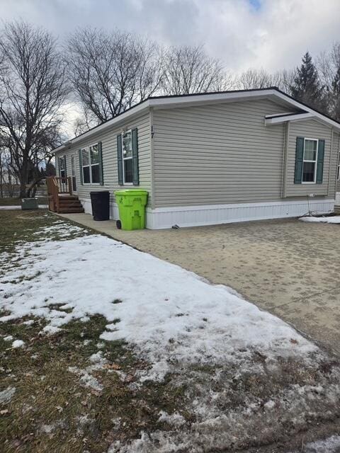 snow covered property with a patio area