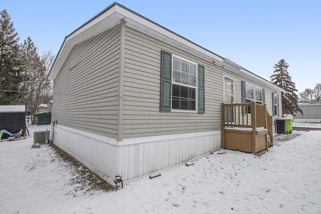 view of snow covered exterior featuring central air condition unit