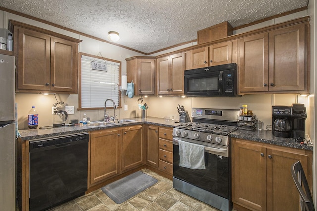 kitchen featuring sink, dark stone counters, ornamental molding, black appliances, and a textured ceiling