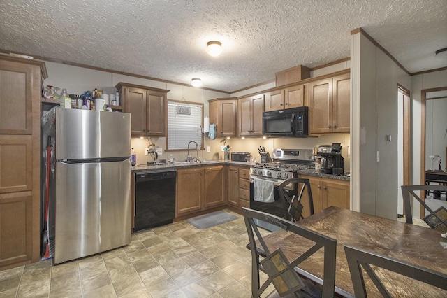 kitchen with crown molding, sink, a textured ceiling, and black appliances