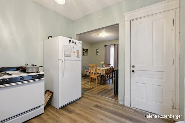 kitchen featuring hardwood / wood-style floors and white appliances