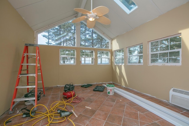 unfurnished sunroom with ceiling fan and vaulted ceiling with skylight