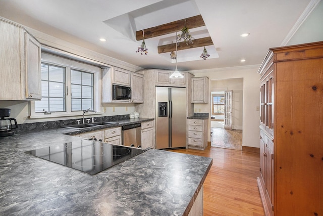 kitchen featuring sink, light hardwood / wood-style flooring, hanging light fixtures, ornamental molding, and black appliances