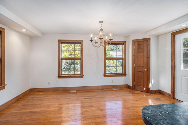 interior space featuring a notable chandelier and light hardwood / wood-style floors