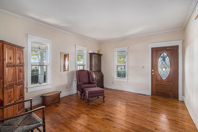 foyer with ornamental molding and dark hardwood / wood-style flooring