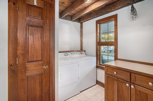 laundry area featuring light tile patterned flooring and washer and clothes dryer