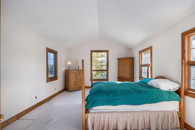 bedroom featuring lofted ceiling and light colored carpet