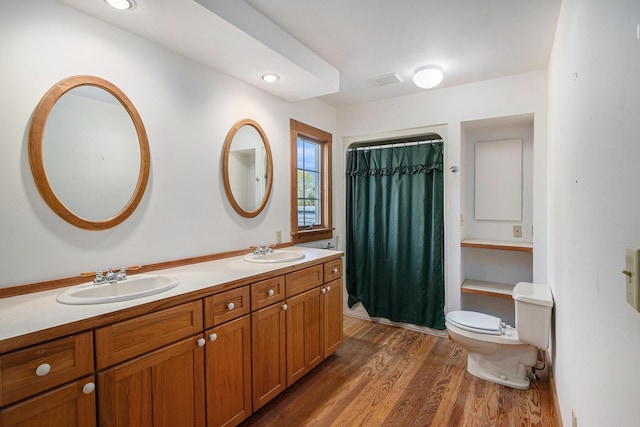 bathroom featuring vanity, hardwood / wood-style floors, and toilet