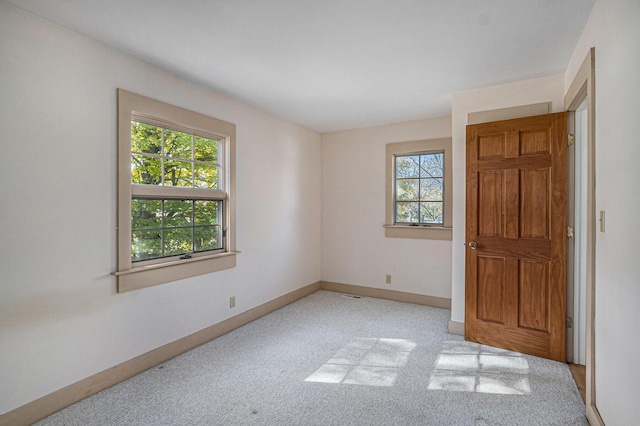 carpeted empty room with a healthy amount of sunlight