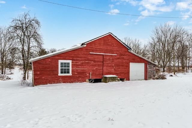 snow covered property featuring an outdoor structure