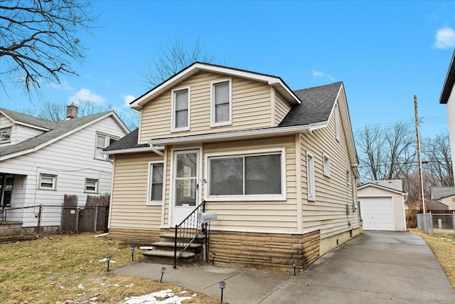 view of front of home featuring a garage and an outbuilding