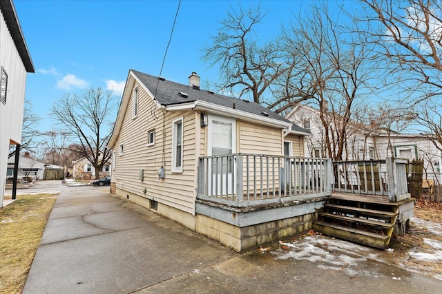 view of property exterior with a wooden deck