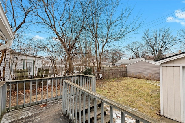 wooden deck featuring a lawn