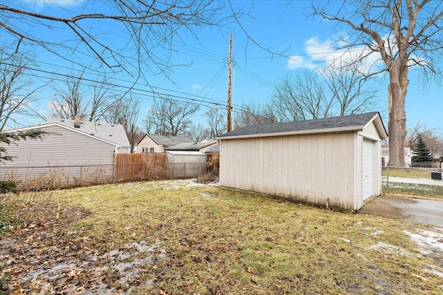 view of yard with a garage and an outbuilding