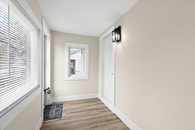 corridor with light wood-type flooring