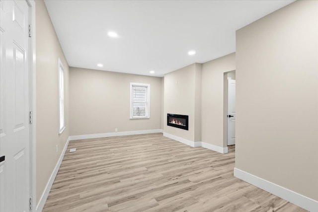 unfurnished living room with light hardwood / wood-style floors