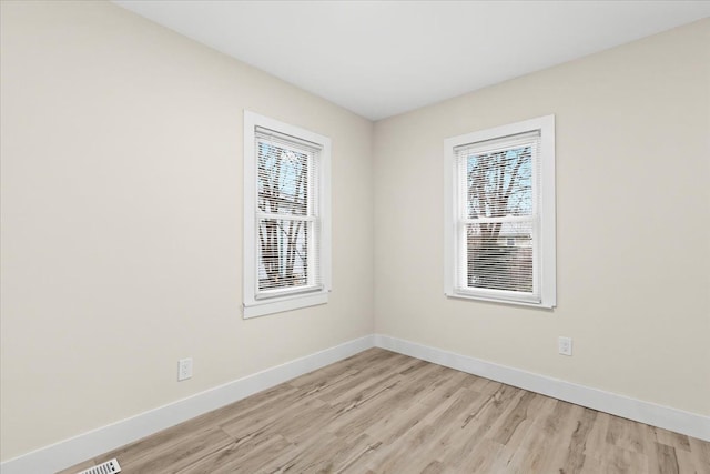 unfurnished room with light wood-type flooring