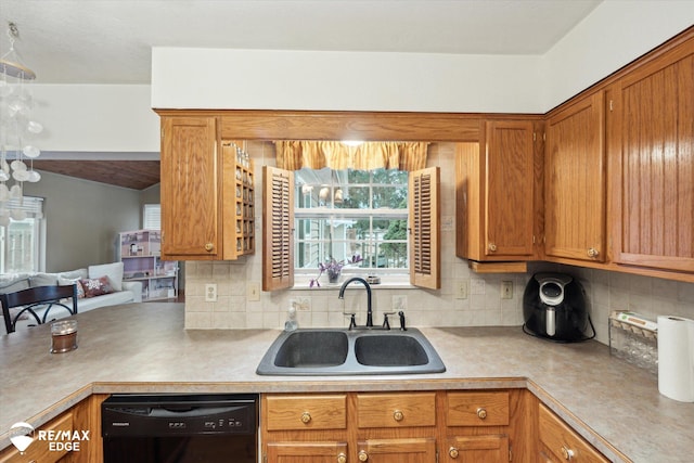 kitchen featuring tasteful backsplash, dishwasher, and sink