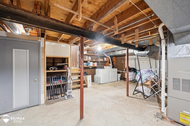 basement featuring heating unit and independent washer and dryer