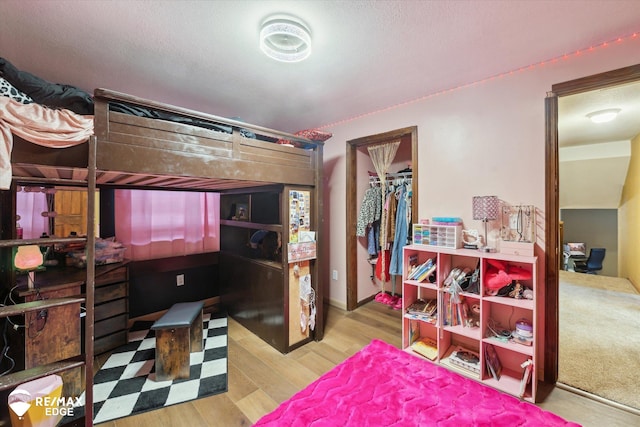 bedroom featuring light wood-type flooring and a closet