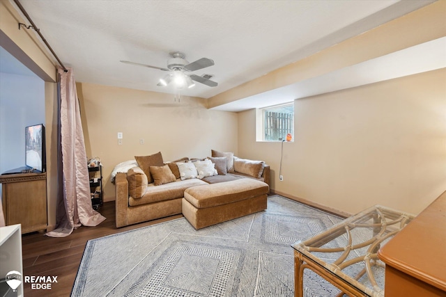 living room with wood-type flooring and ceiling fan