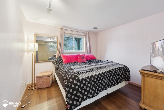 bedroom featuring dark hardwood / wood-style flooring