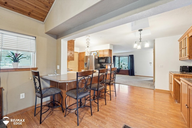 dining room with light hardwood / wood-style floors and a chandelier