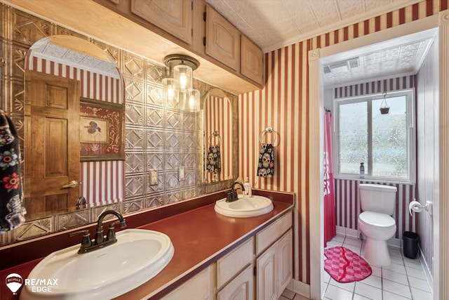 bathroom with crown molding, vanity, toilet, and tile patterned flooring