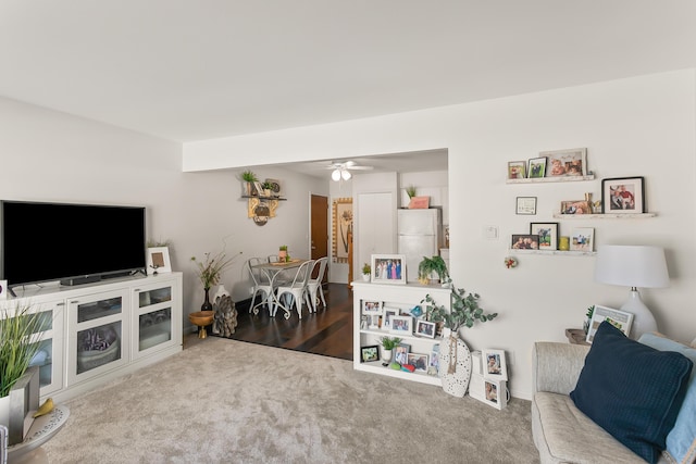 living room with ceiling fan and carpet