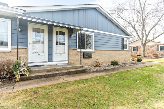 property entrance featuring brick siding