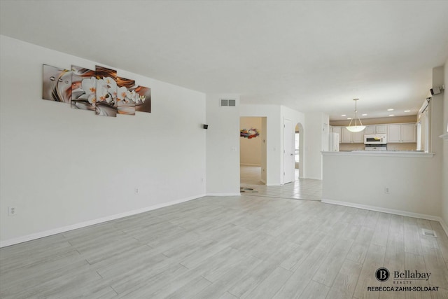 unfurnished living room with light wood-type flooring