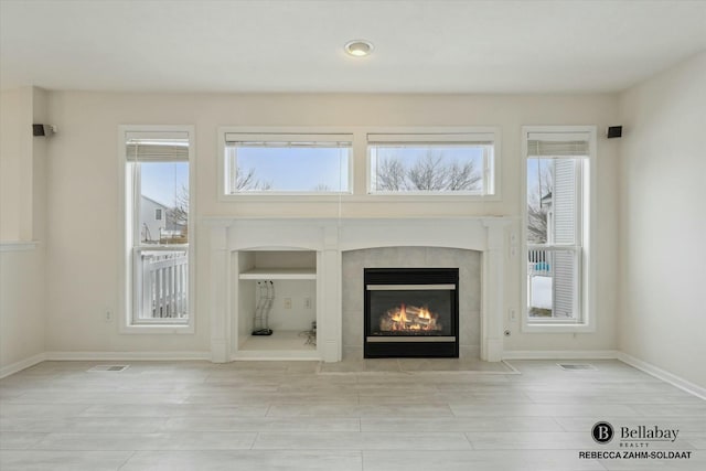 unfurnished living room with a fireplace and light hardwood / wood-style flooring