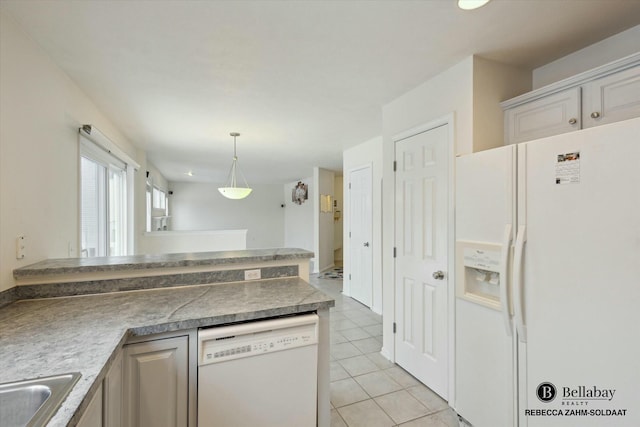 kitchen featuring pendant lighting, light tile patterned floors, white appliances, and sink