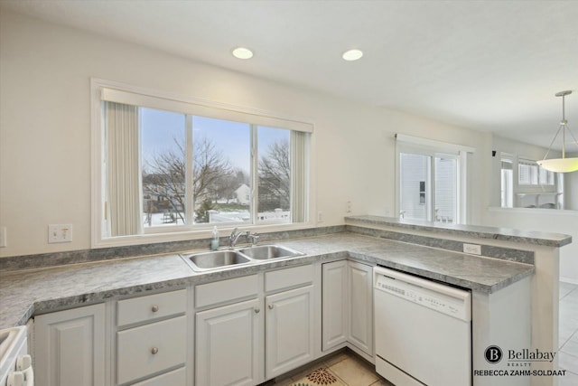 kitchen with sink, dishwasher, hanging light fixtures, white cabinets, and light tile patterned flooring