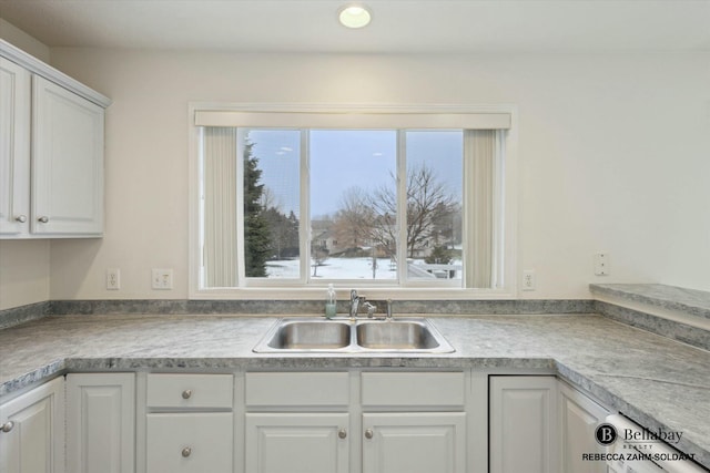 kitchen featuring white cabinetry, a healthy amount of sunlight, and sink