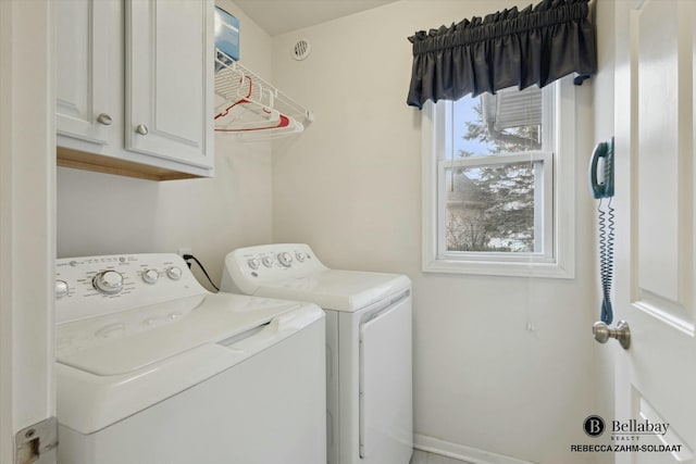 laundry area with cabinets and washer and clothes dryer