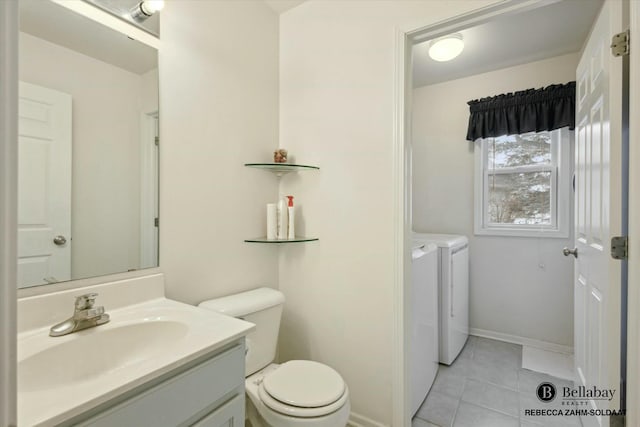 bathroom featuring vanity, tile patterned floors, washer and clothes dryer, and toilet