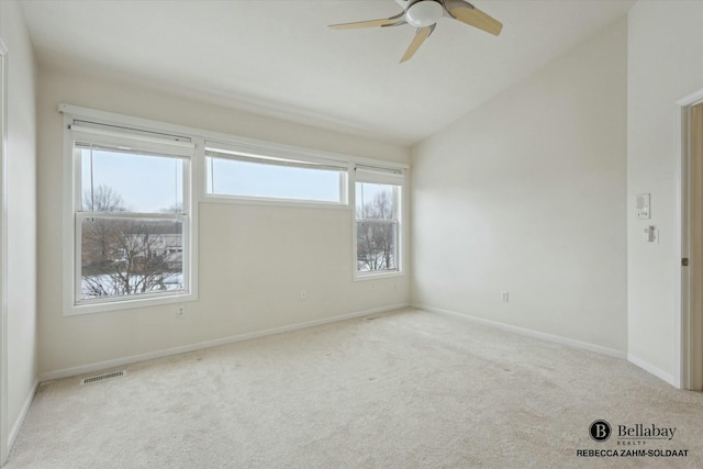 unfurnished room with light carpet, vaulted ceiling, and ceiling fan