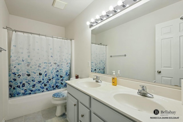 full bathroom with vanity, toilet, tile patterned flooring, and shower / tub combo